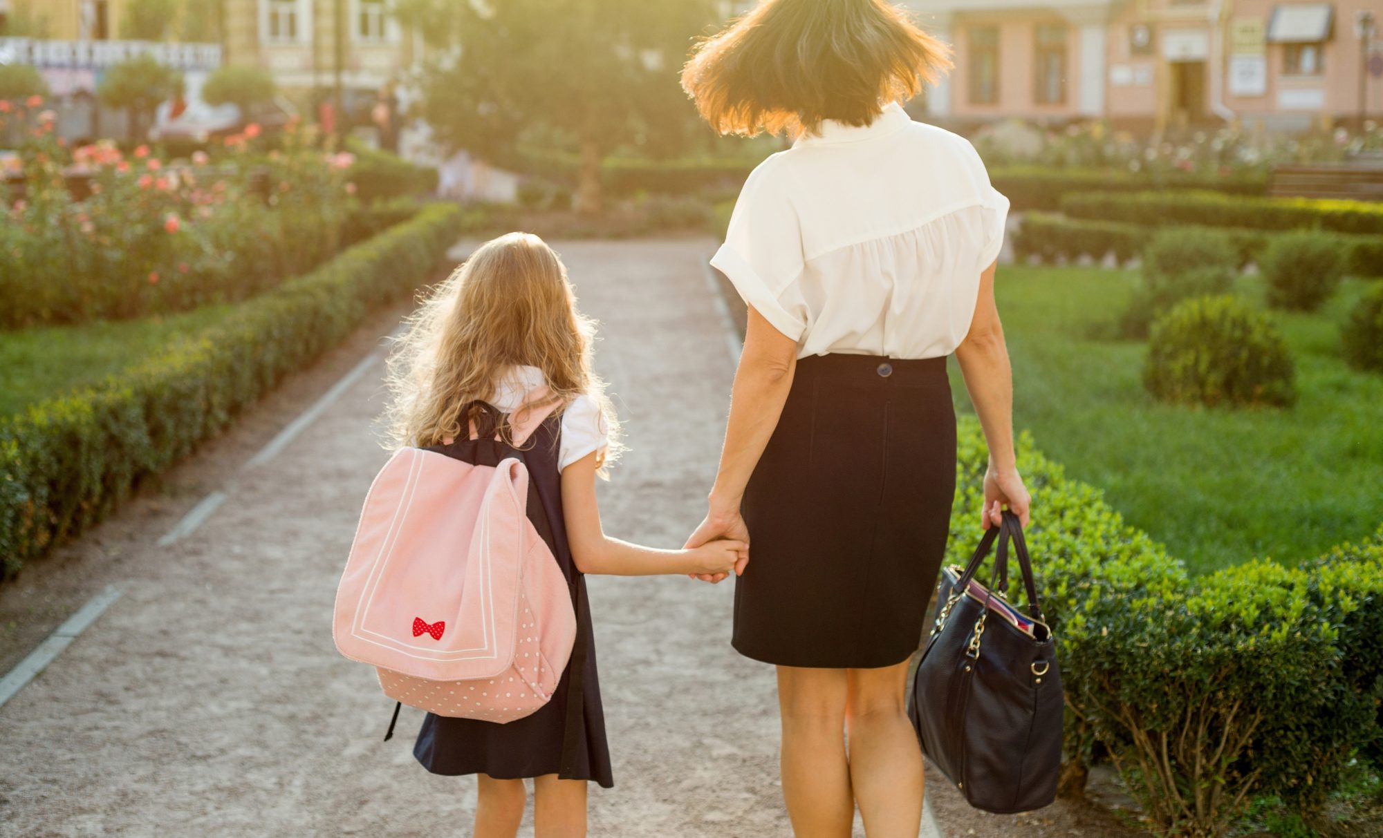 A mother walking her daughter to school